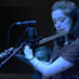 Flautist Jess Shand plays Breathing Together bathed in cool light